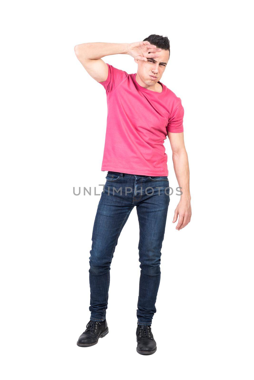 Full length tired male in jeans and pink t shirt touching forehead and looking at camera while suffering from hot weather isolated on white background