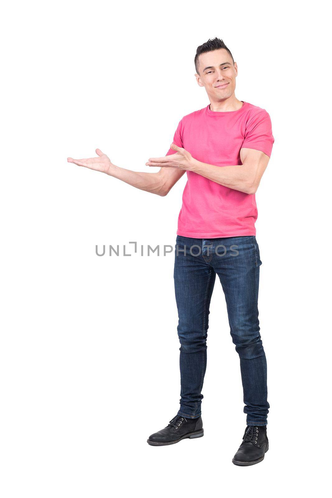 Full body of happy male in casual clothes pointing aside with hands and looking at camera while standing isolated on white background