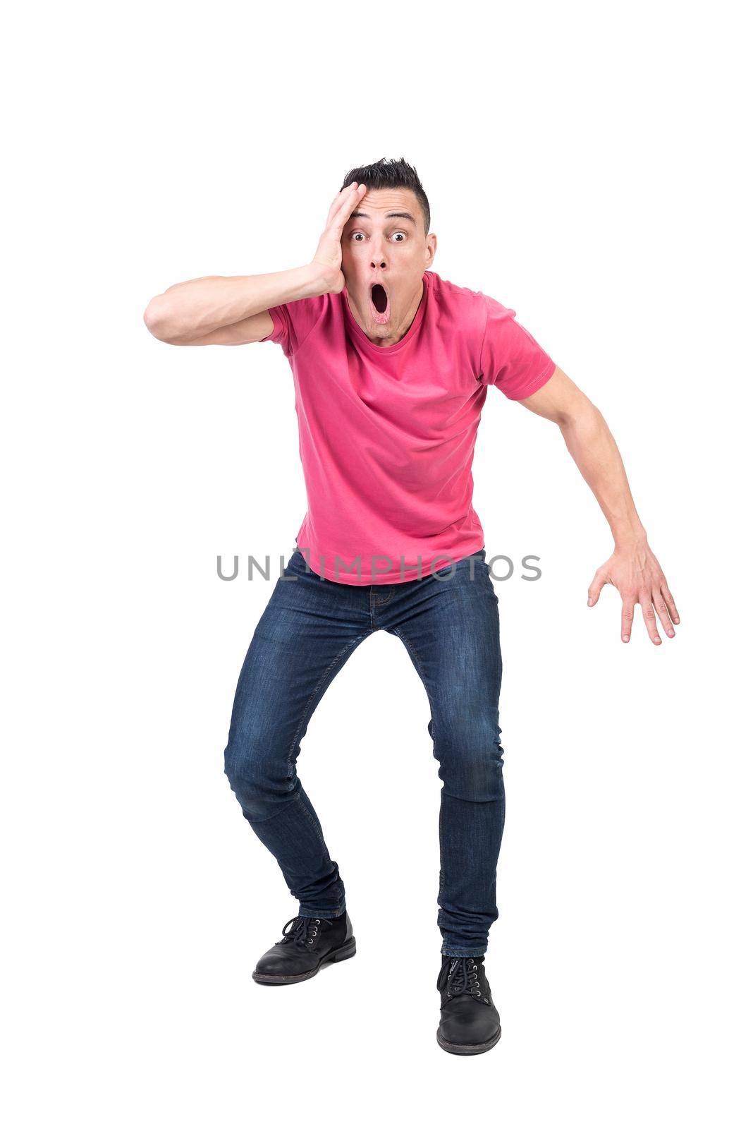 Full body of amazed male touching face and looking at camera with opened mouth isolated on white background in studio