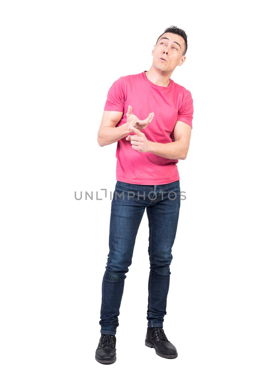 Full body of pensive male recalling numbers while counting on fingers in studio against white background