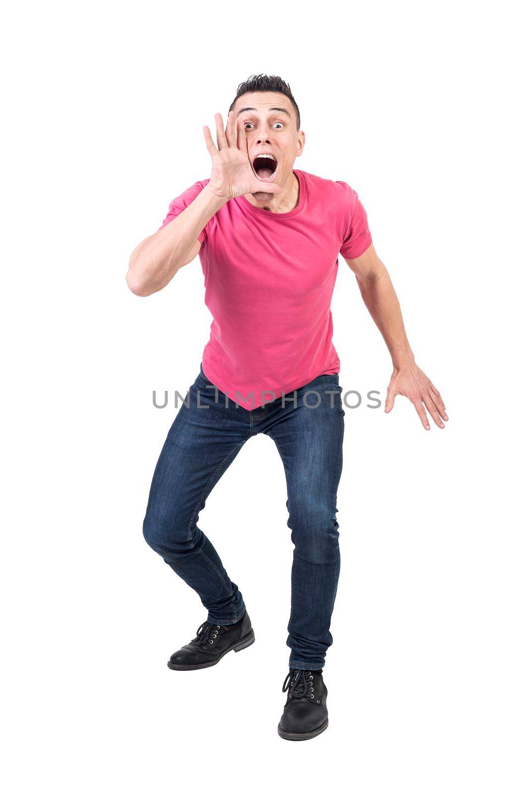 Full body of excited male model announcing news and shouting loud with hand at mouth on white background and looking at camera