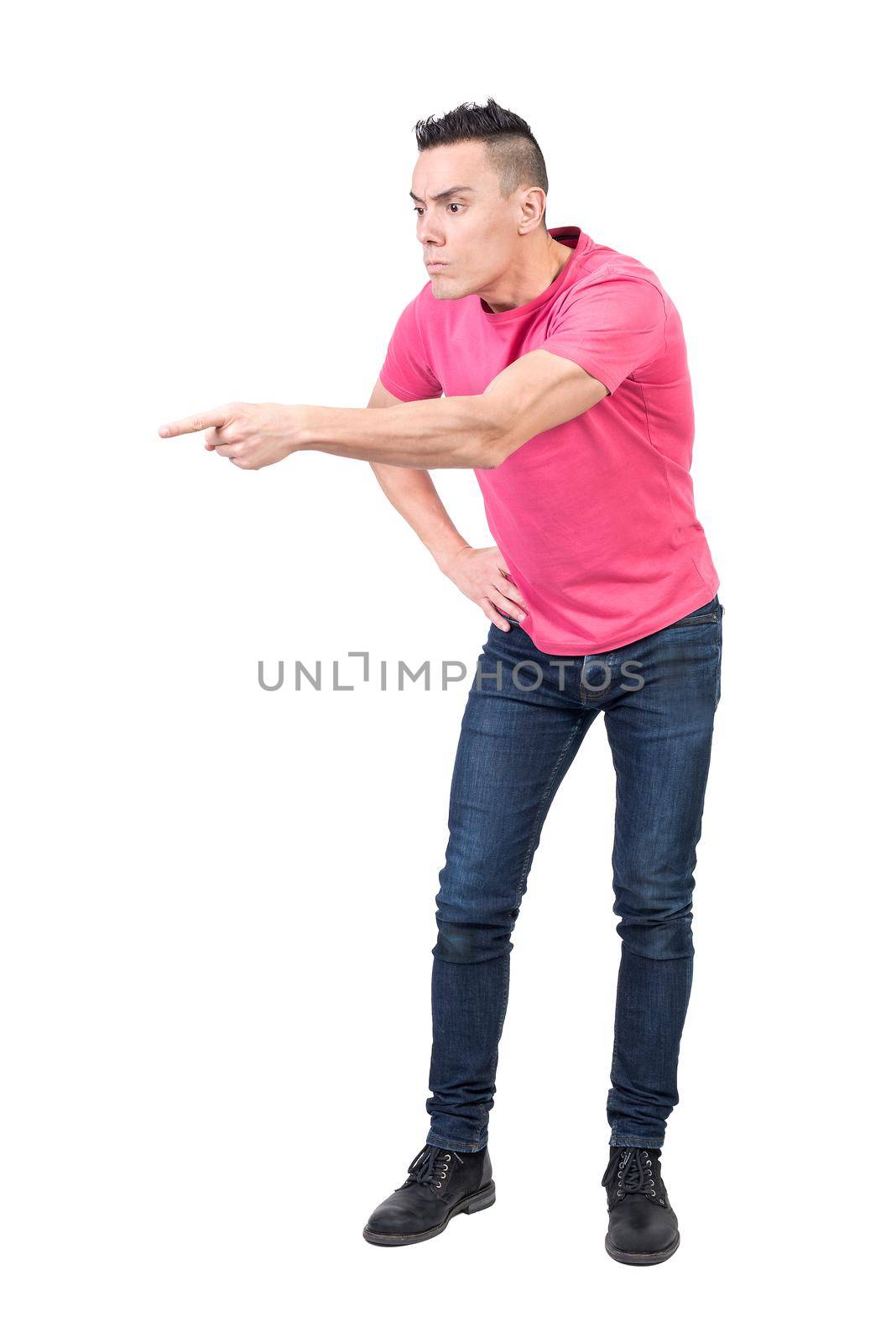 Full body of irritate male model pointing away while scolding and blaming for bad behavior in studio on white background