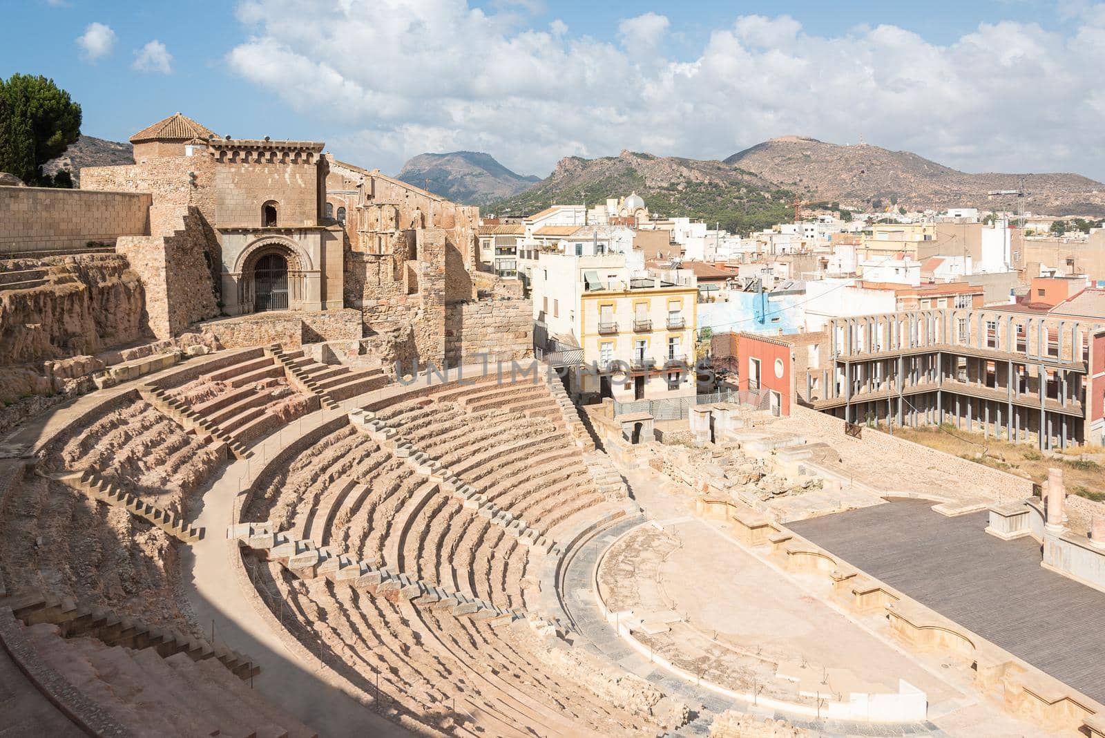 From above of architectural monument of aged stone ruined of Roman theater of Cartagena in sunny summer day