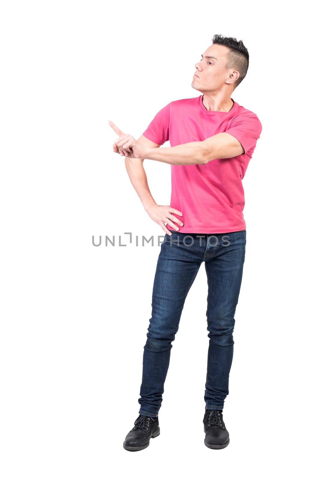 Full body of serious male model standing with hand on waist and showing reject gesture while scolding and expressing bad attitude on white background