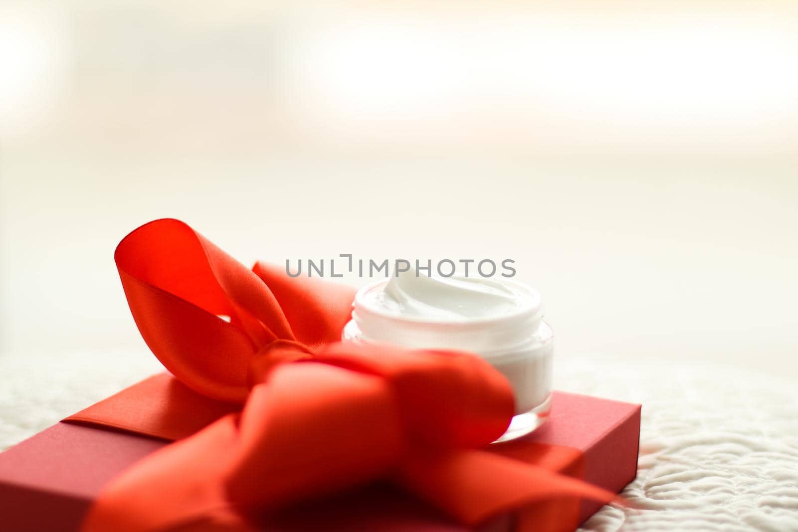 Beauty, cosmetics and skincare styled concept - Luxury face cream jar and red gift box