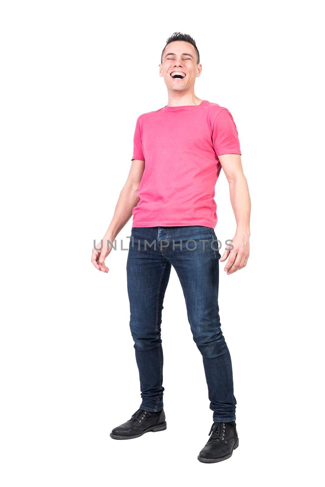 Full body of cheerful male model in casual outfit laughing on funny story with closed eyes and opened mouth on white background