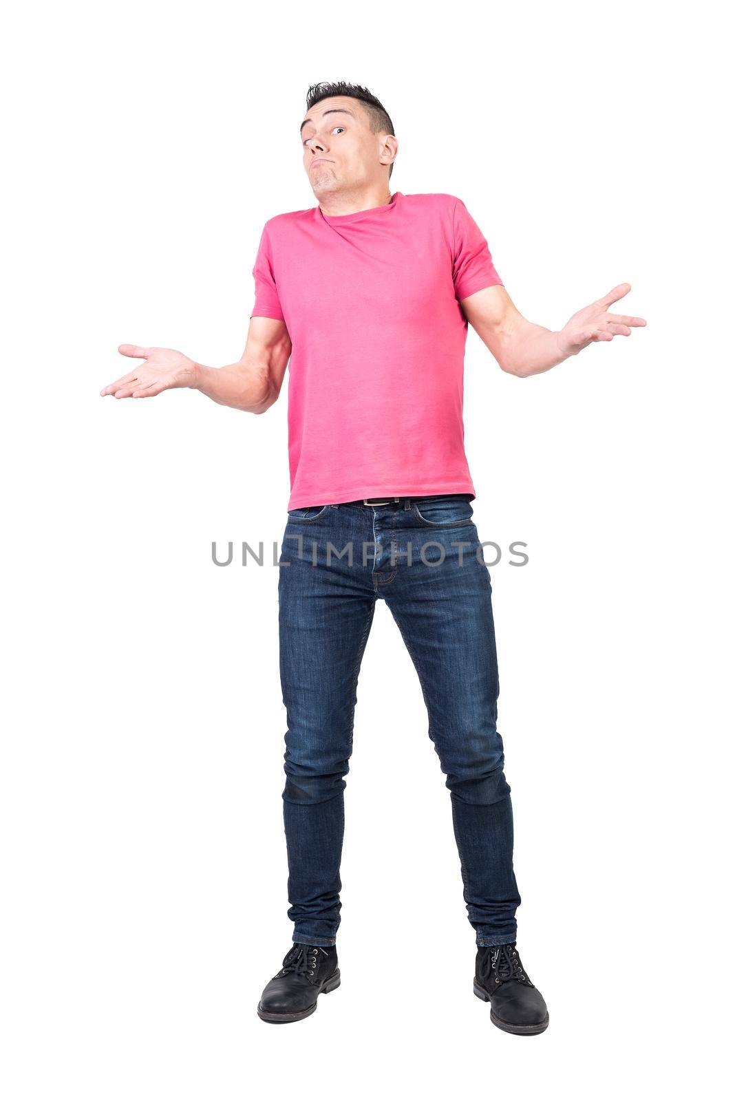 Full body of puzzled male model in casual outfit showing ignorance and unawareness on white background