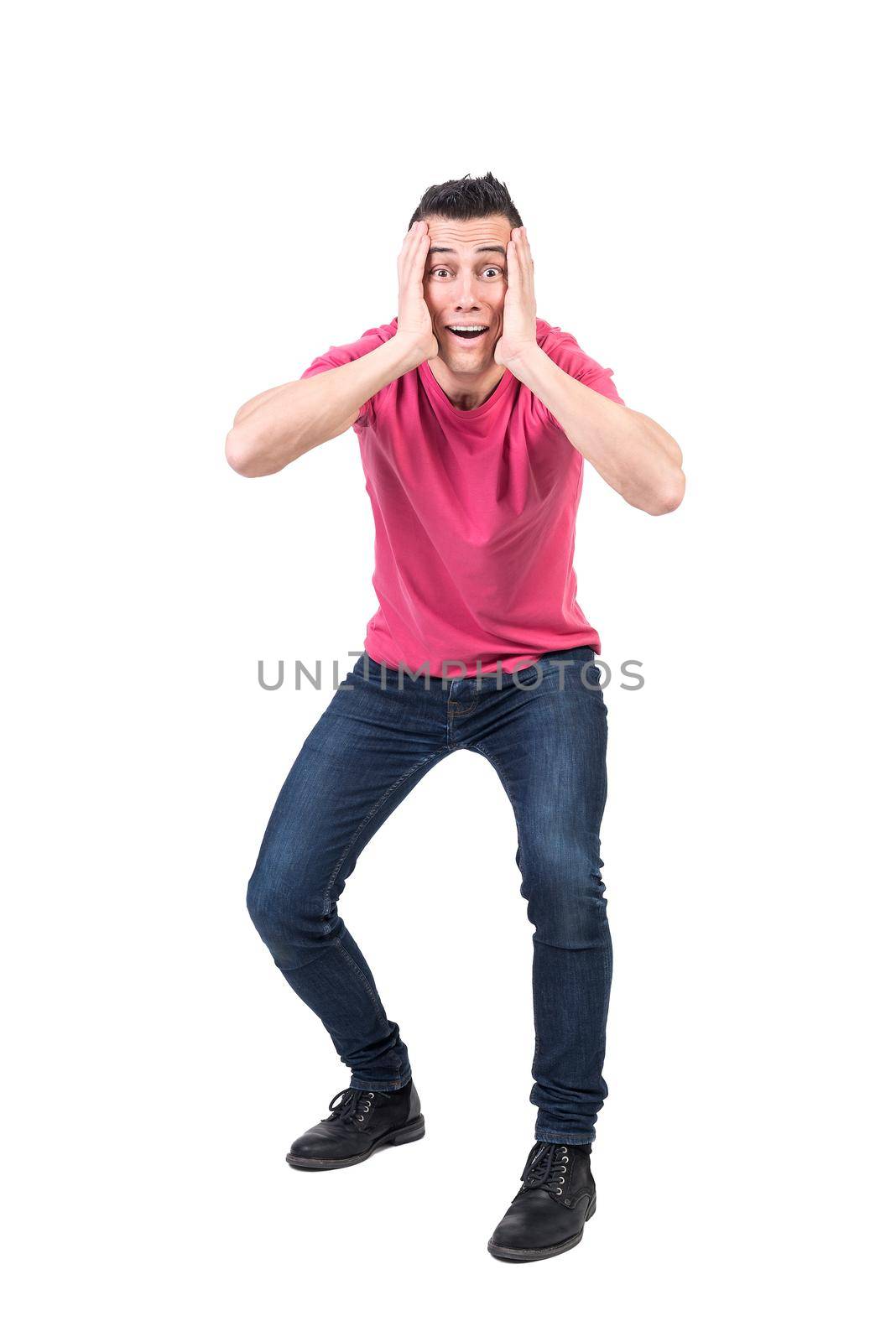 Full body of shocked male with hands on face looking at camera with astonished face isolated on white background in studio