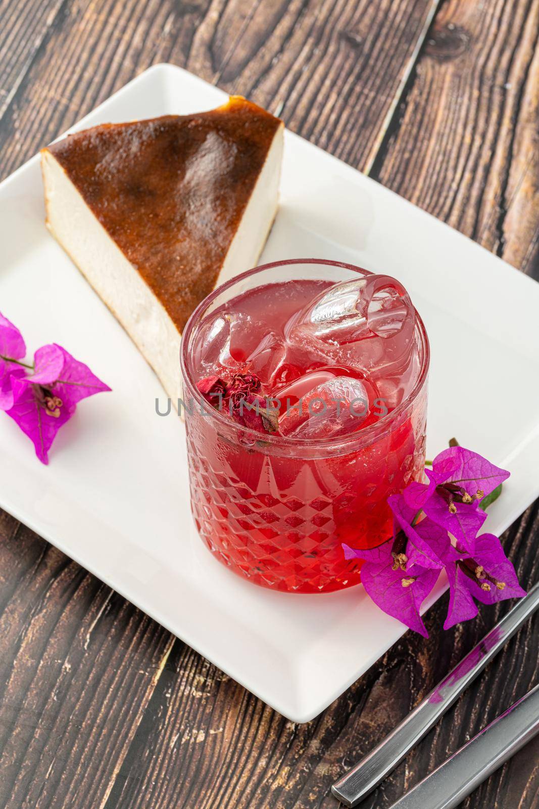 Strawberry tea and san sebastian cheesecake on wooden table by Sonat