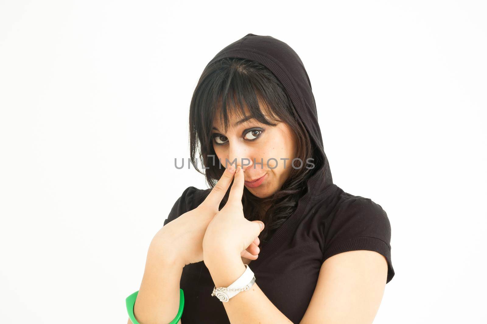Brunette girl in a funny posture, looking at camera, on white background, close up