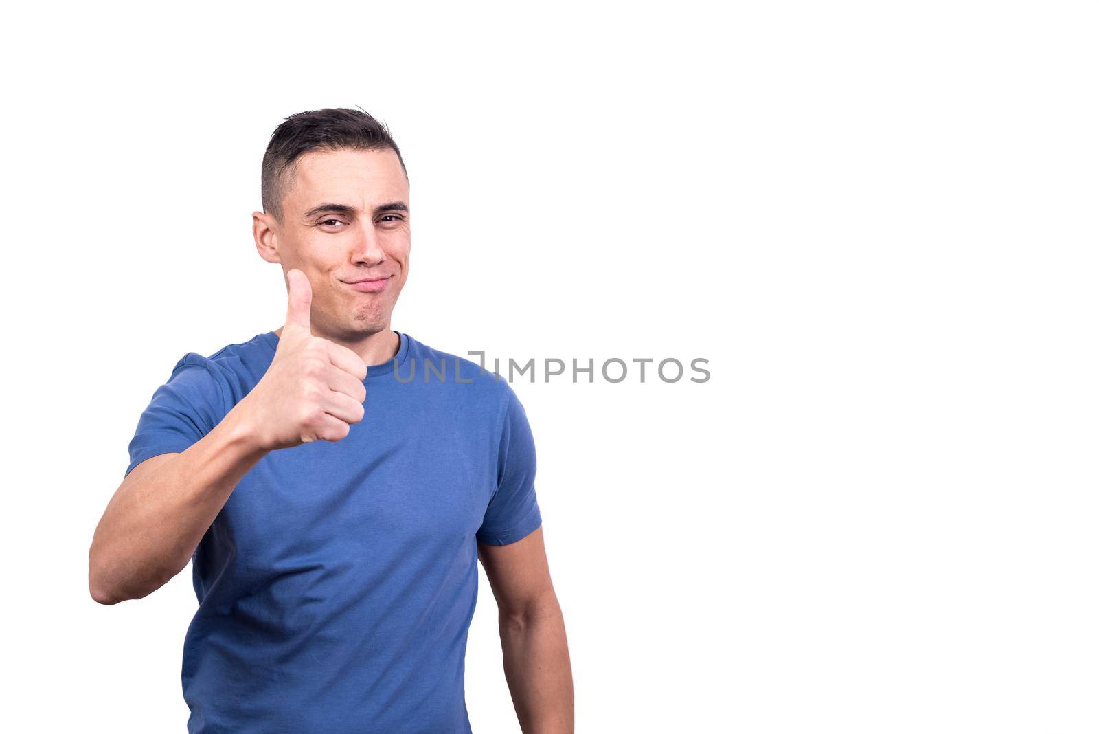 Studio portrait with white background of a man giving thumb up gesturing to be okay