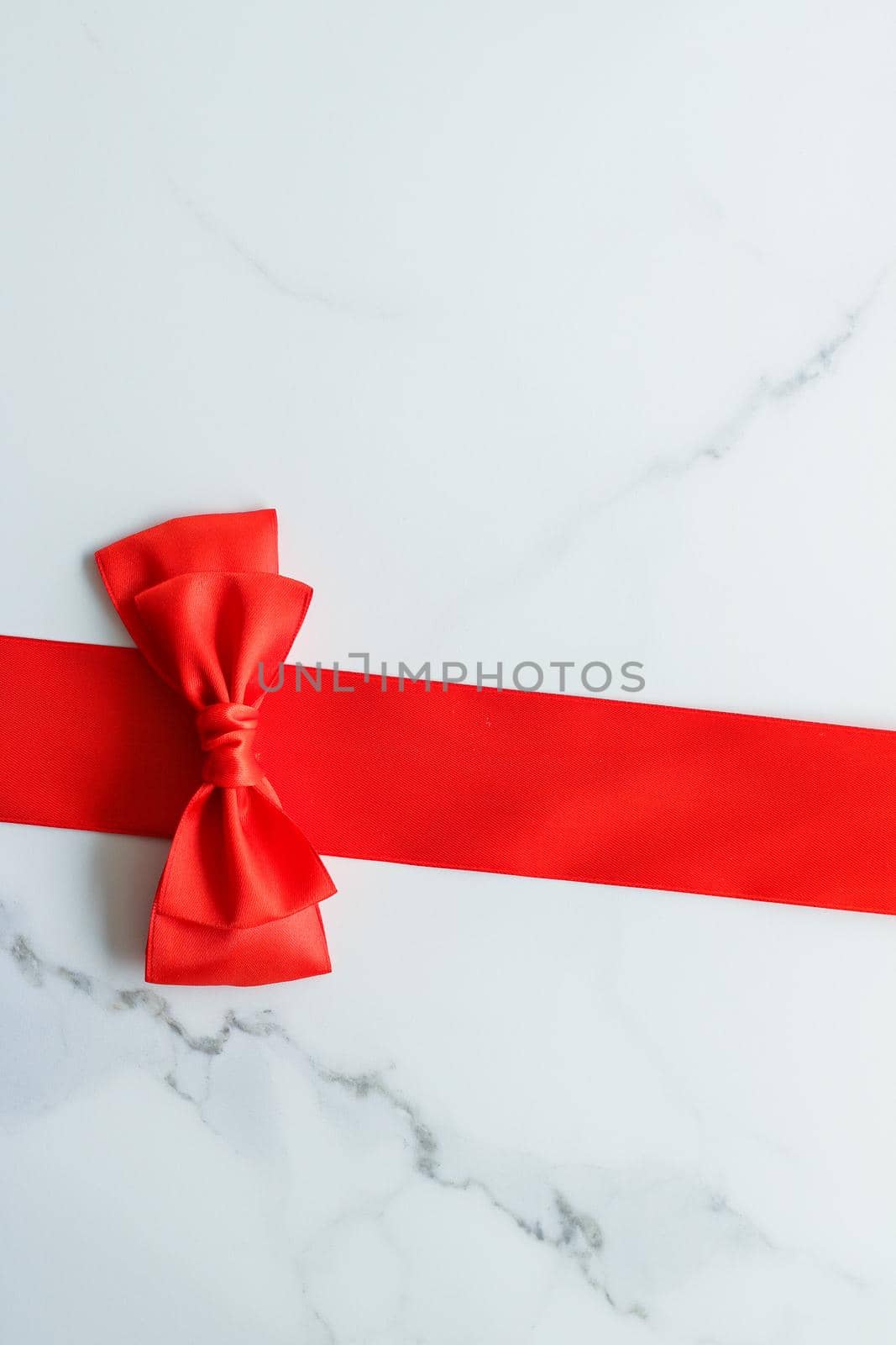 Holiday decor, feminine design and flatlay concept - Red silk ribbon on marble, top view