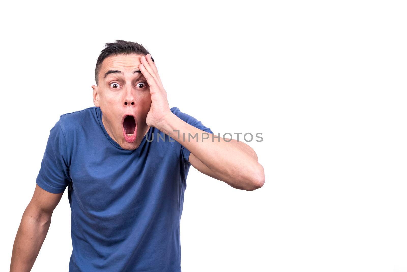 Studio portrait with white background of a man with hand onthe face and expression of surprise