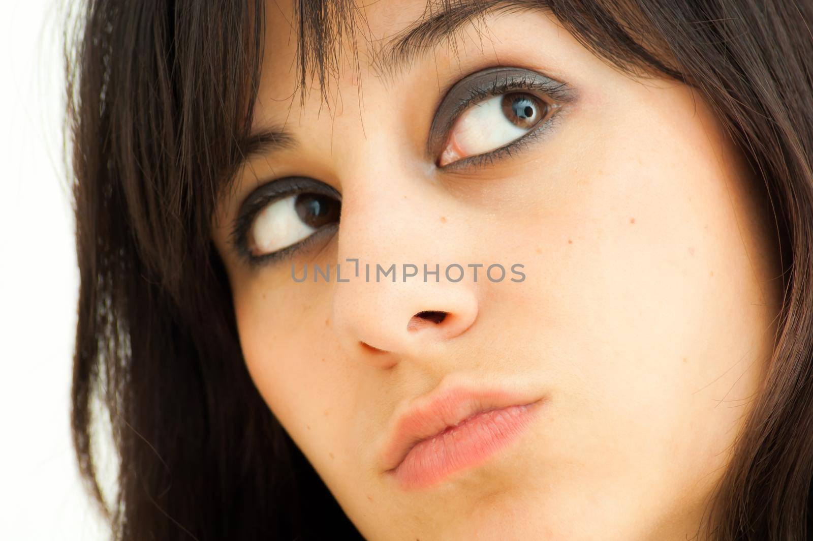 Pretty brunette girl looking aside, on white background, close up