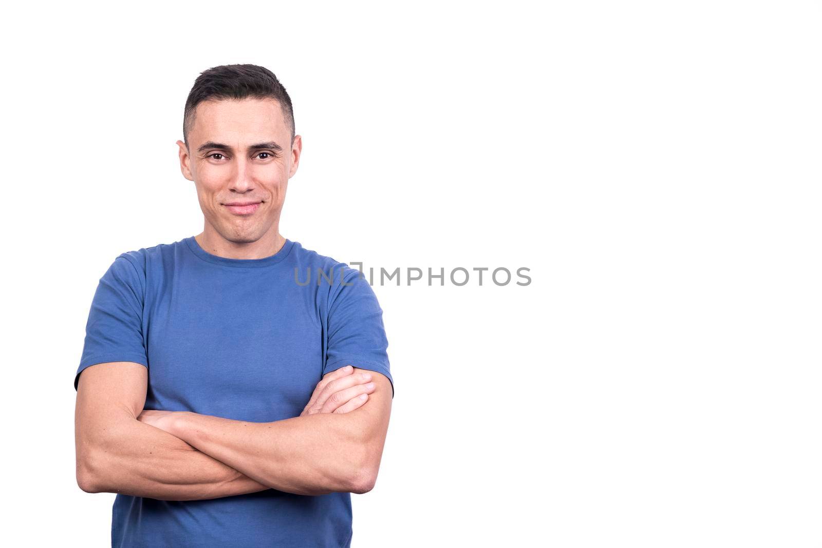 Studio portrait with white background of a man with arms crossed while smiling