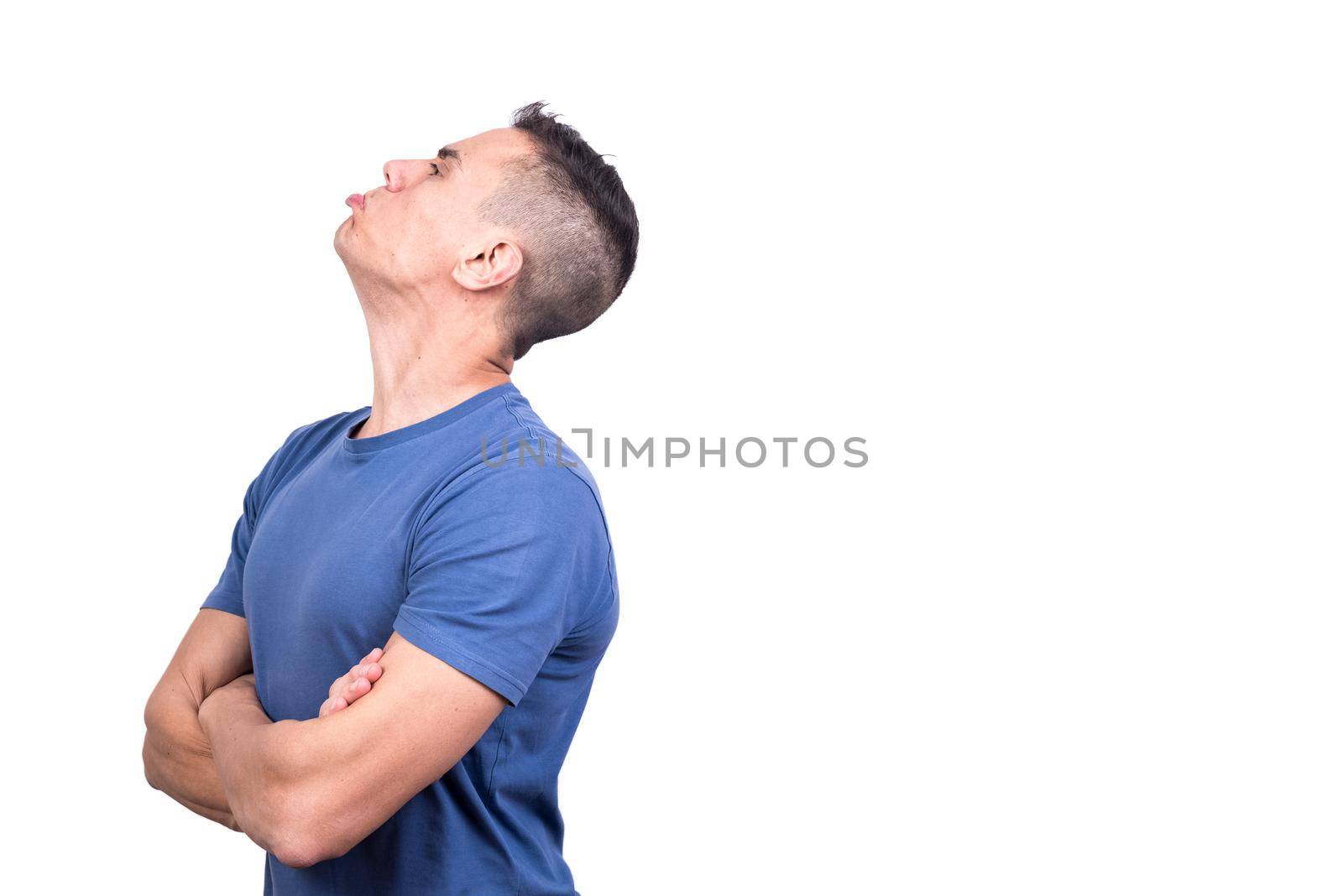 Studio portrait with white background of a man turned in profile with an expression of anger