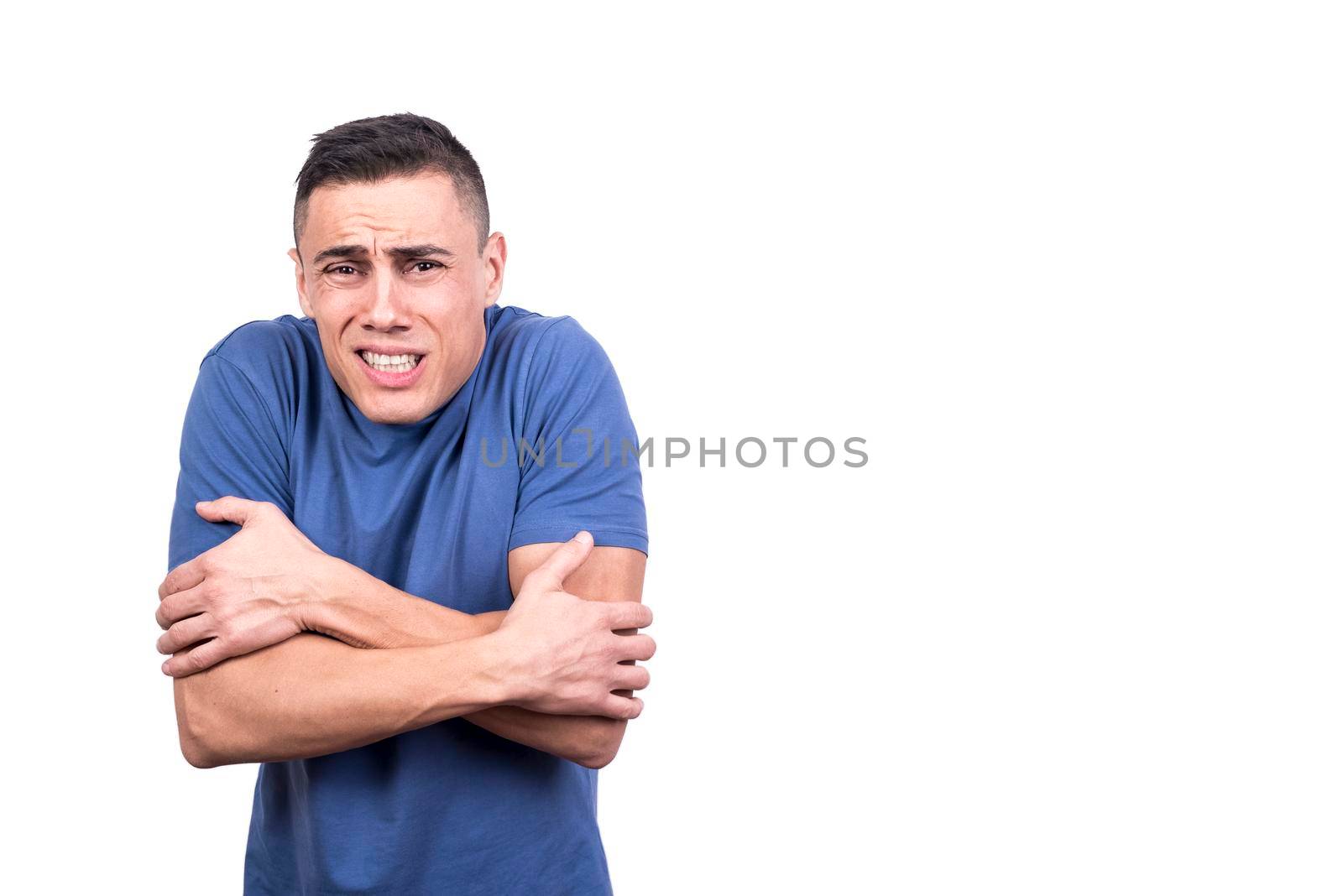 Studio photo with white background of a man gesturing that he is cold while facing the camera
