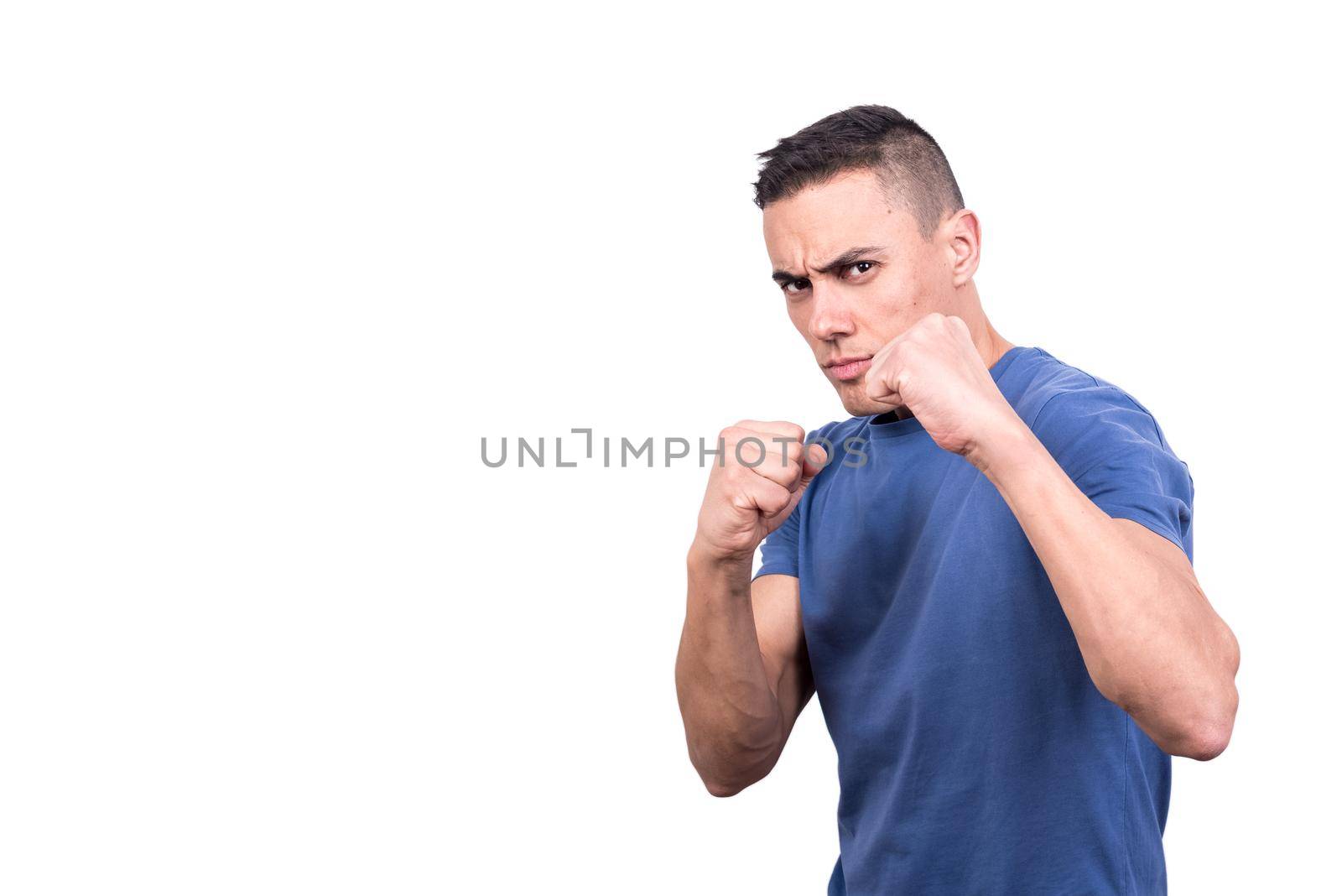 Studio portrait with white background of a man in casual clothes in boxing guard