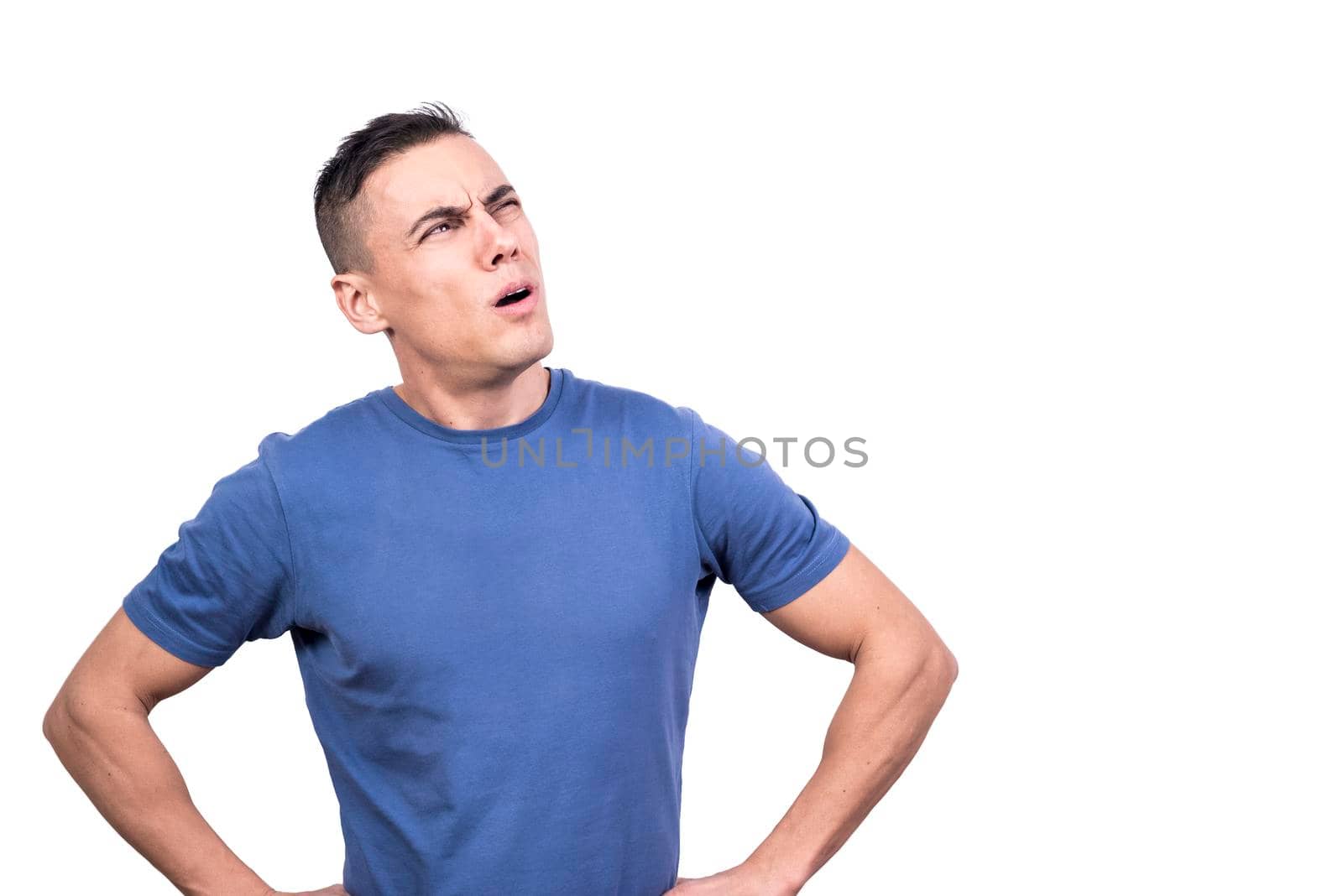 Studio portrait if a man looking aside with expression of doubt with a white background
