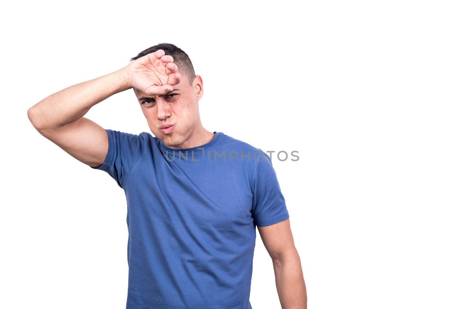 Studio photo with white background of a man gesturing that he is hot with his arm on his forehead
