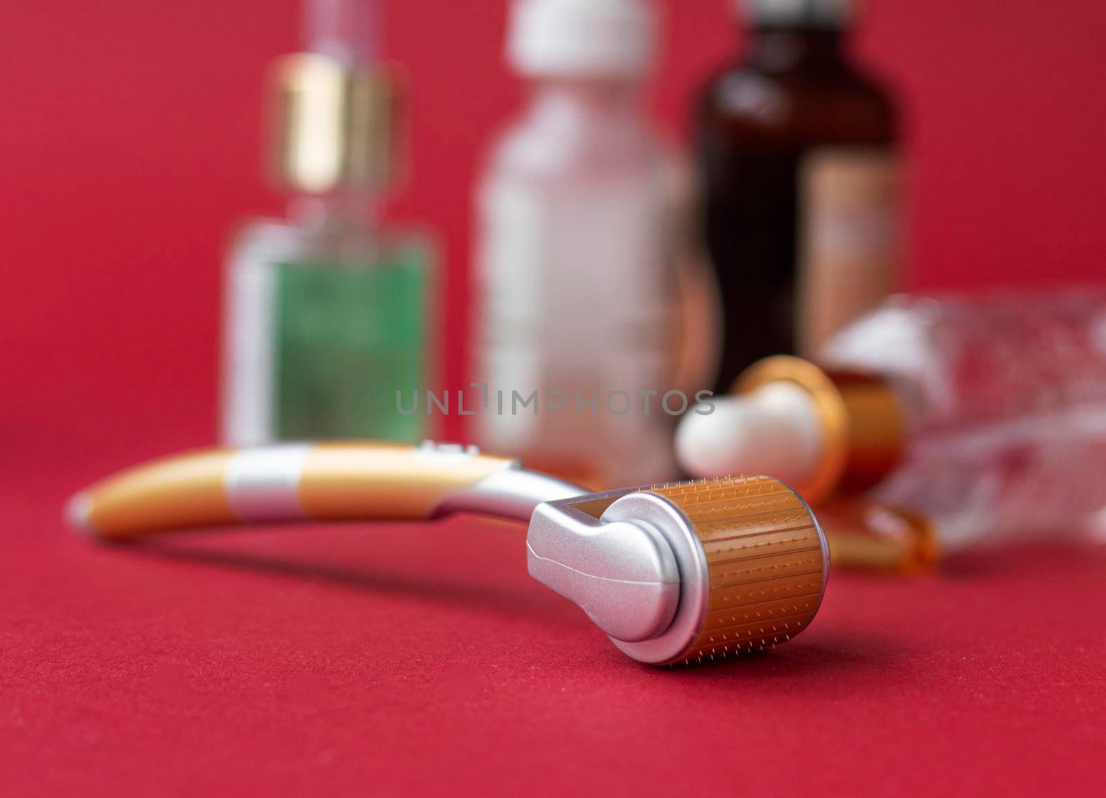 Dermaroller needle with serum in glass bottle. Anti wrinkle skin care. Derma roller and serum bottle. Beauty treatment, mesotherapy or medical collagen production stimulation. . High quality photo