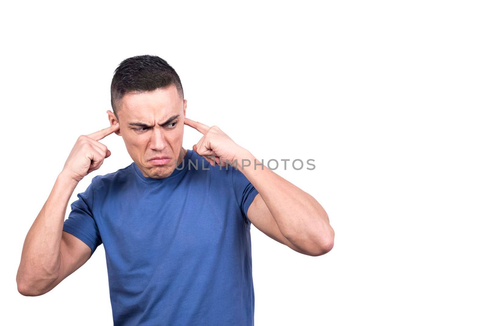 Studio portrait with white background of a man covering his ears with fingers while looking aside