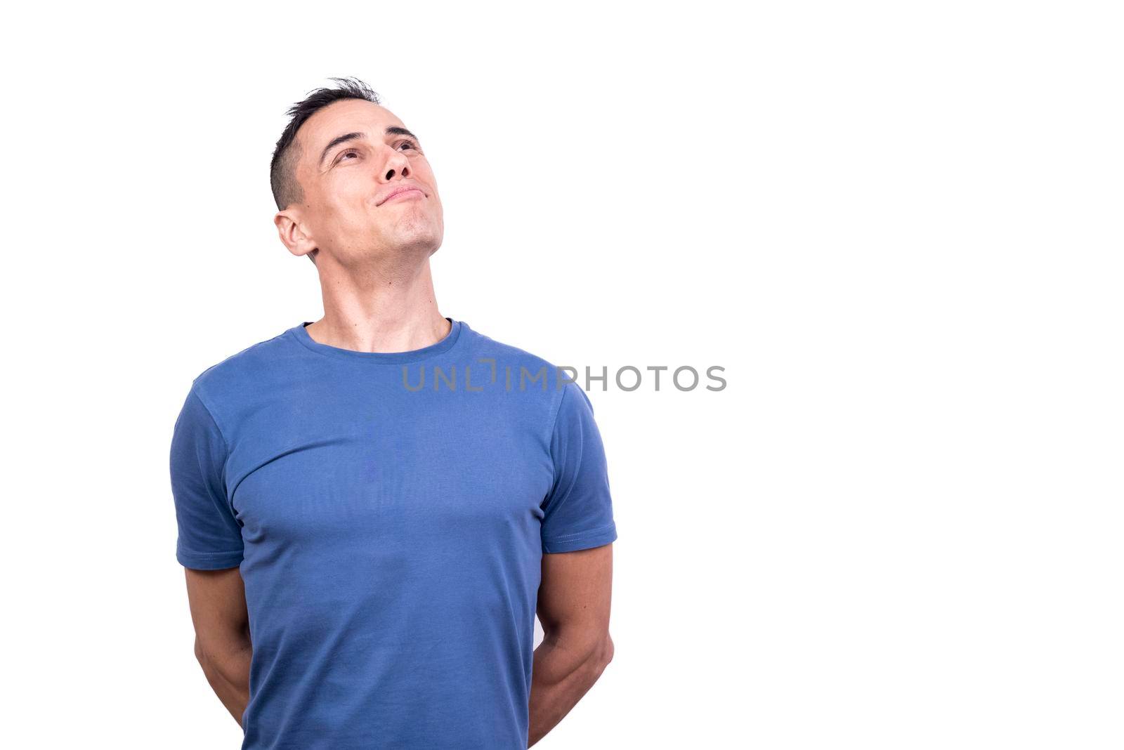 Studio portrait with white background of a happy smiling man looking up