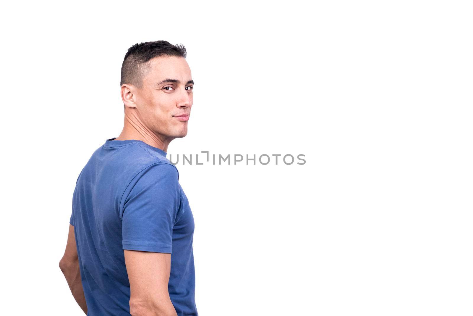 Studio portrait with white background of a man trurning to the camera with cocky expression