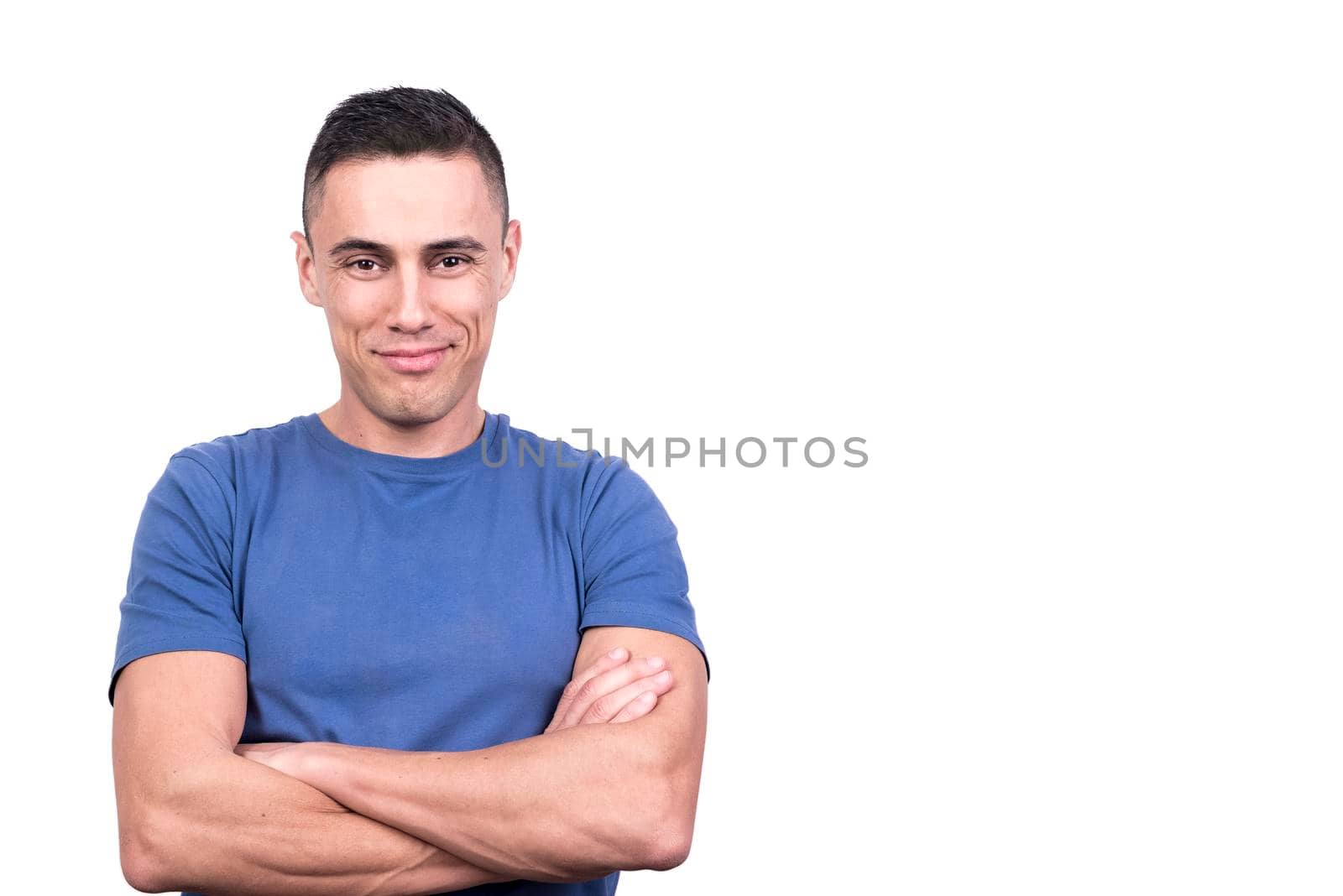 Studio portrait with white background of a smiling man with arms crossed and relaxed expression