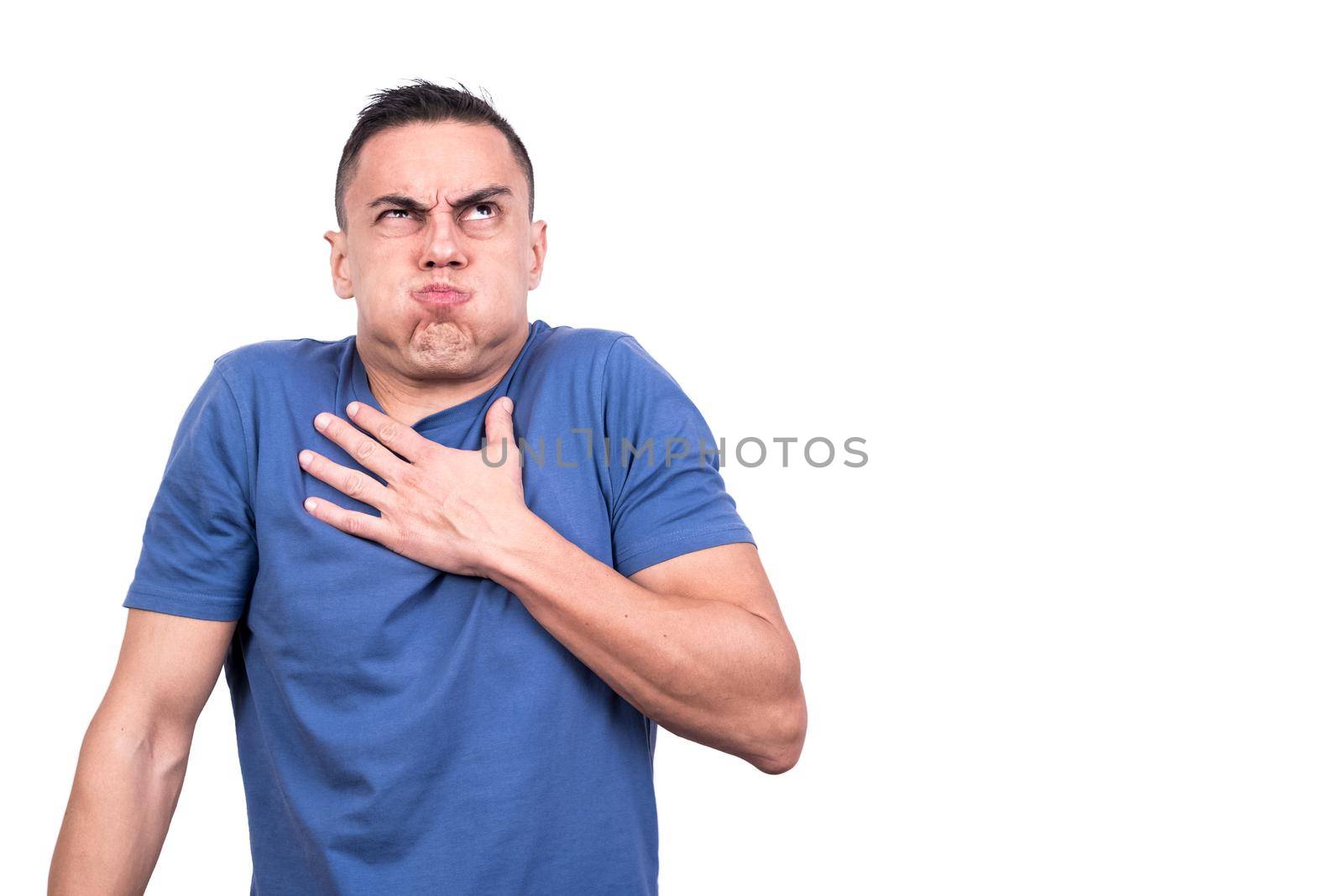 Man with his hand on his chest holding his breath while looking upwards in a white background