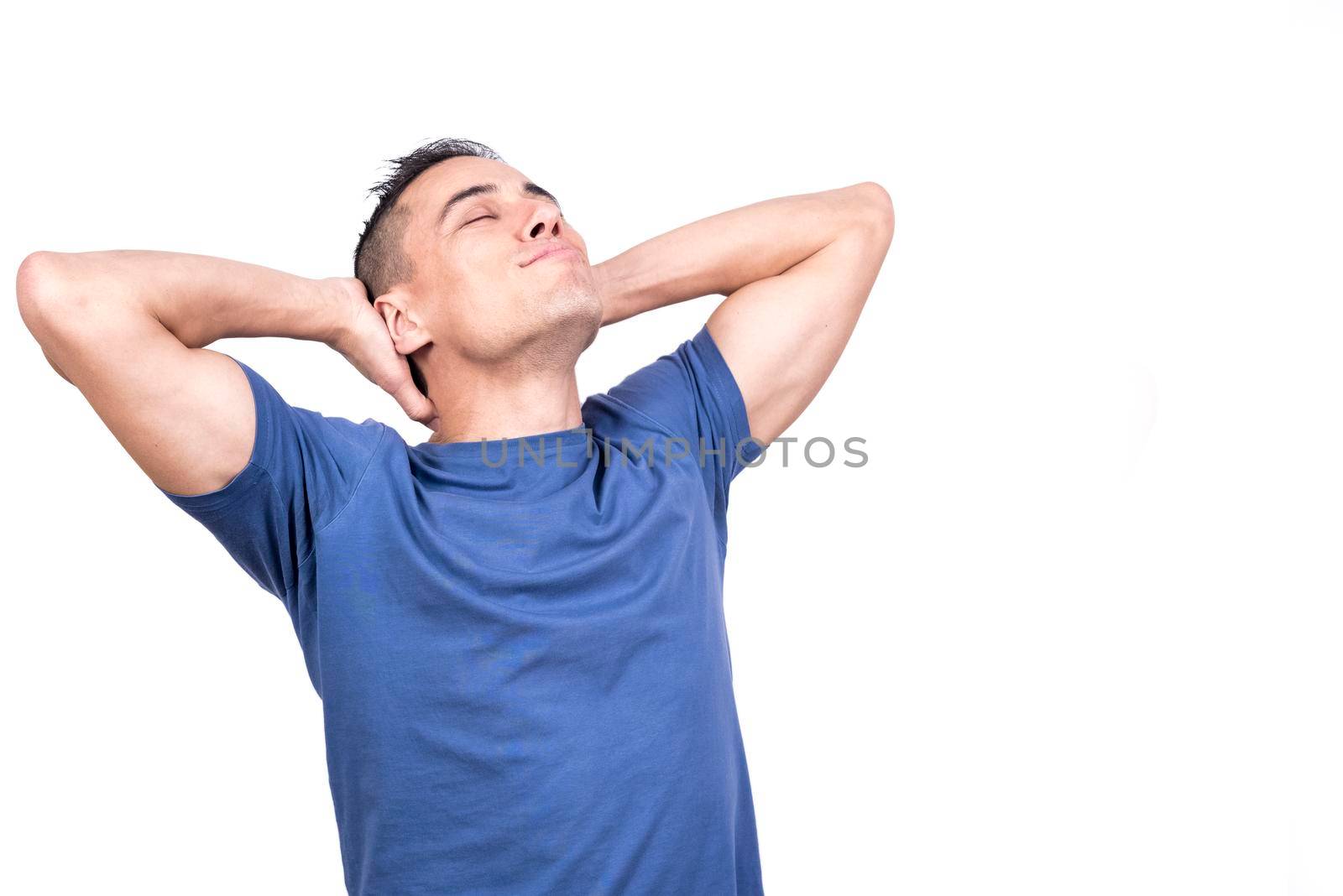 Studio photo with white background of a man with his hands on the back of his neck relaxing