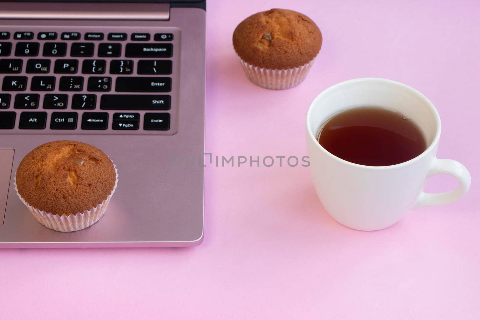 a cup of tea near a laptop. fresh muffins by Suietska