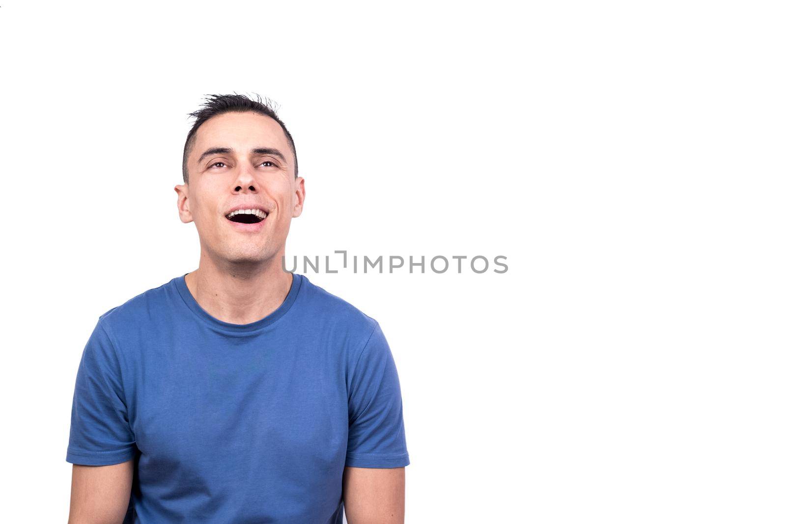 Studio portrait with white background of a man looking up with a smoked expression