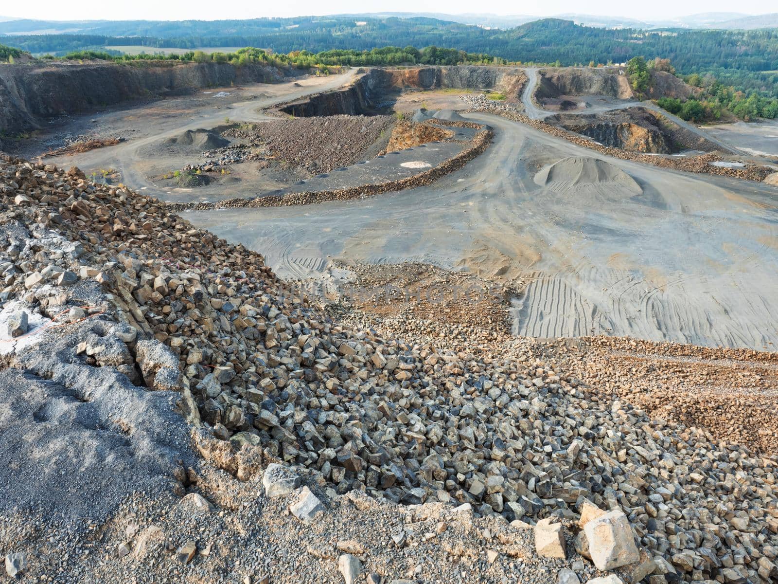 Basalt quarry. Marks of excavator operating in a rock quarry.The manufacture and production of broken phonolite. The main stone is grey clinkstone