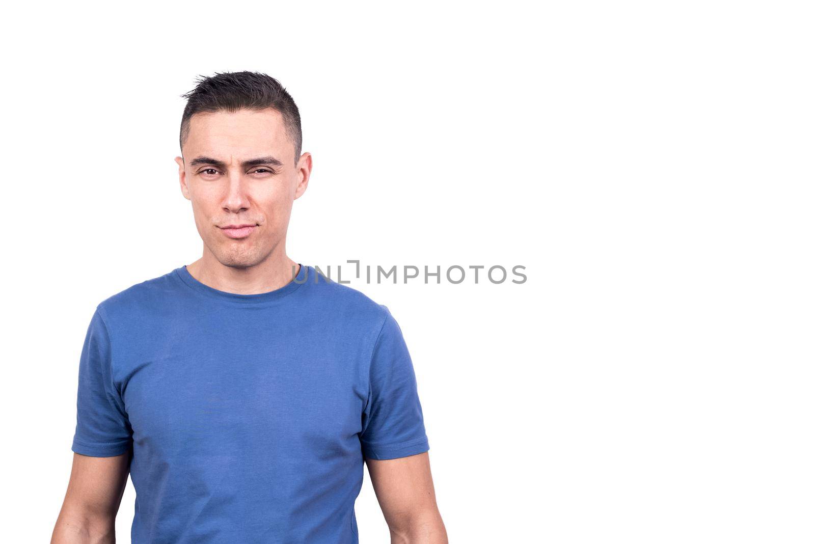 Studio photo with white background of a man looking at camera with cheeky smile