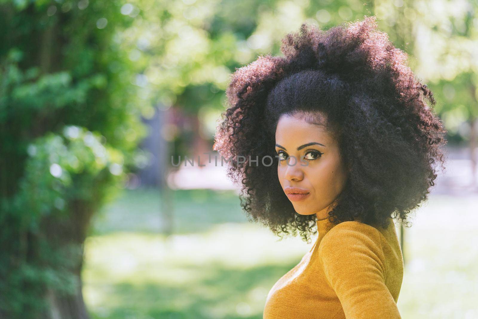 Portrait of nice afro girl in a garden. Close up. by ivanmoreno