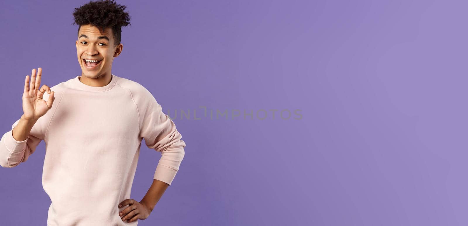 Relax its okay. Portrait of carefree, unbothered young man have everything under control, assure and guarantee job will be done, recommend product, being pleased, purple background.