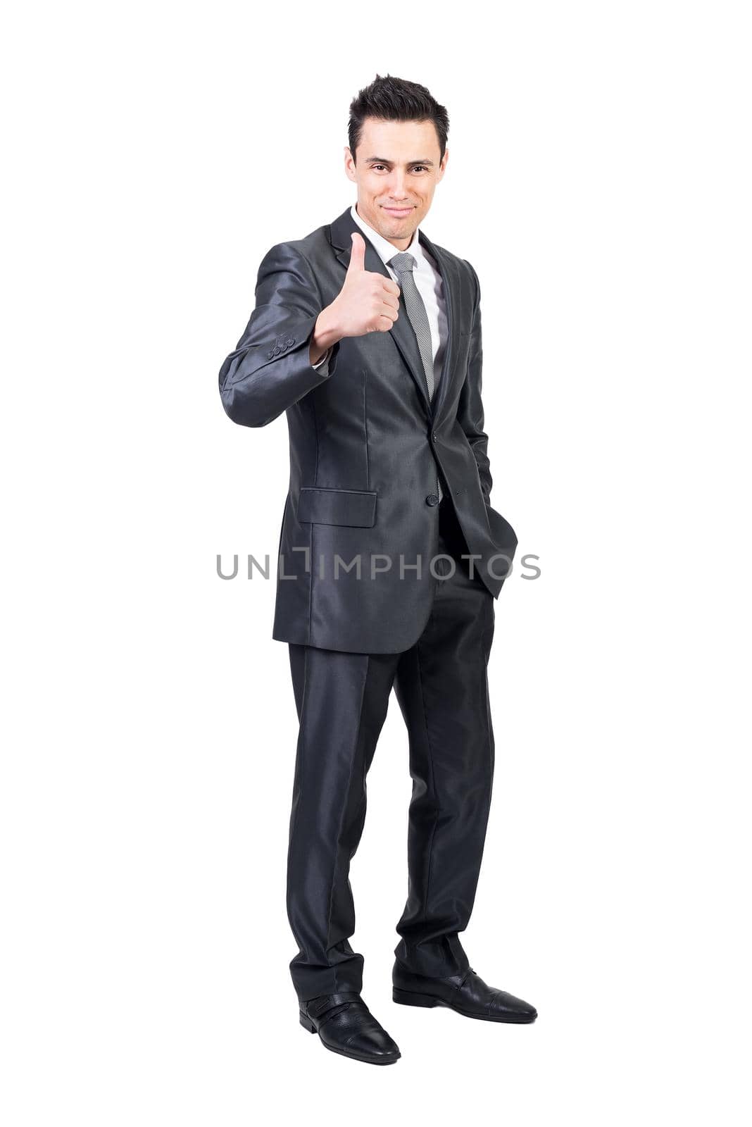 Full length of positive male entrepreneur in formal suit showing thumb up and looking at camera on white isolated background