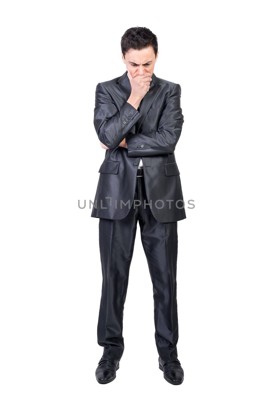 Full body of confused male worker in formal suit touching face while thinking on serious problem in studio against white background