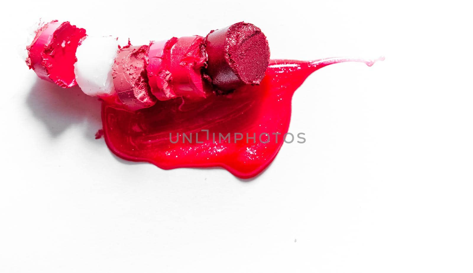 Beauty texture, cosmetic product and art of make-up concept - Cutted and liquid lipstick close-up isolated on white background