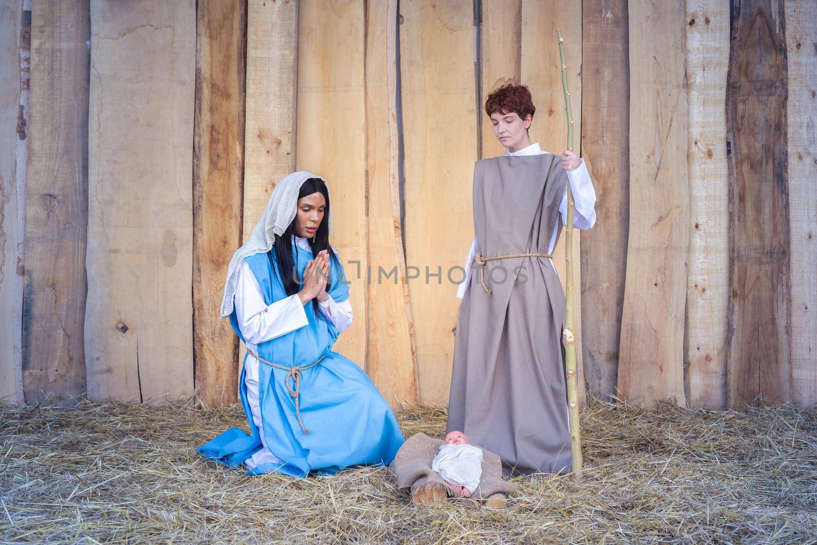 Christmas crib with two transgender people representing a scene of Mary and Joseph
