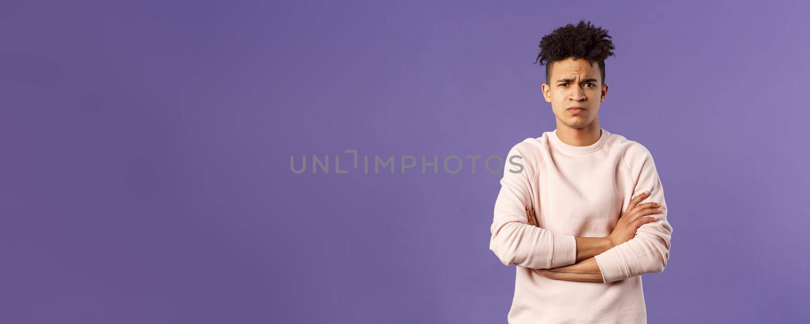 Portrait of young offended hispanic boyfriend, frowning and looking judgemental upset at camera, cross hands over chest defensive insulted pose, standing purple background angry at someone by Benzoix