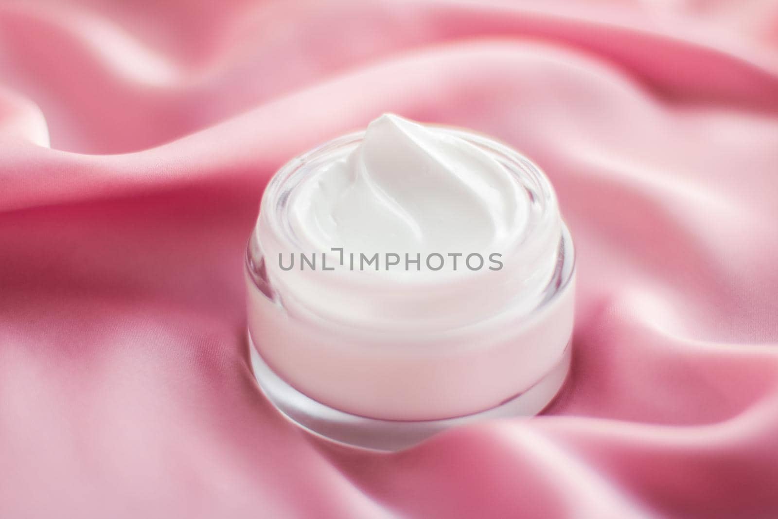 Beauty, anti-age cosmetics and skincare concept - Luxury face cream jar on a soft pink silk