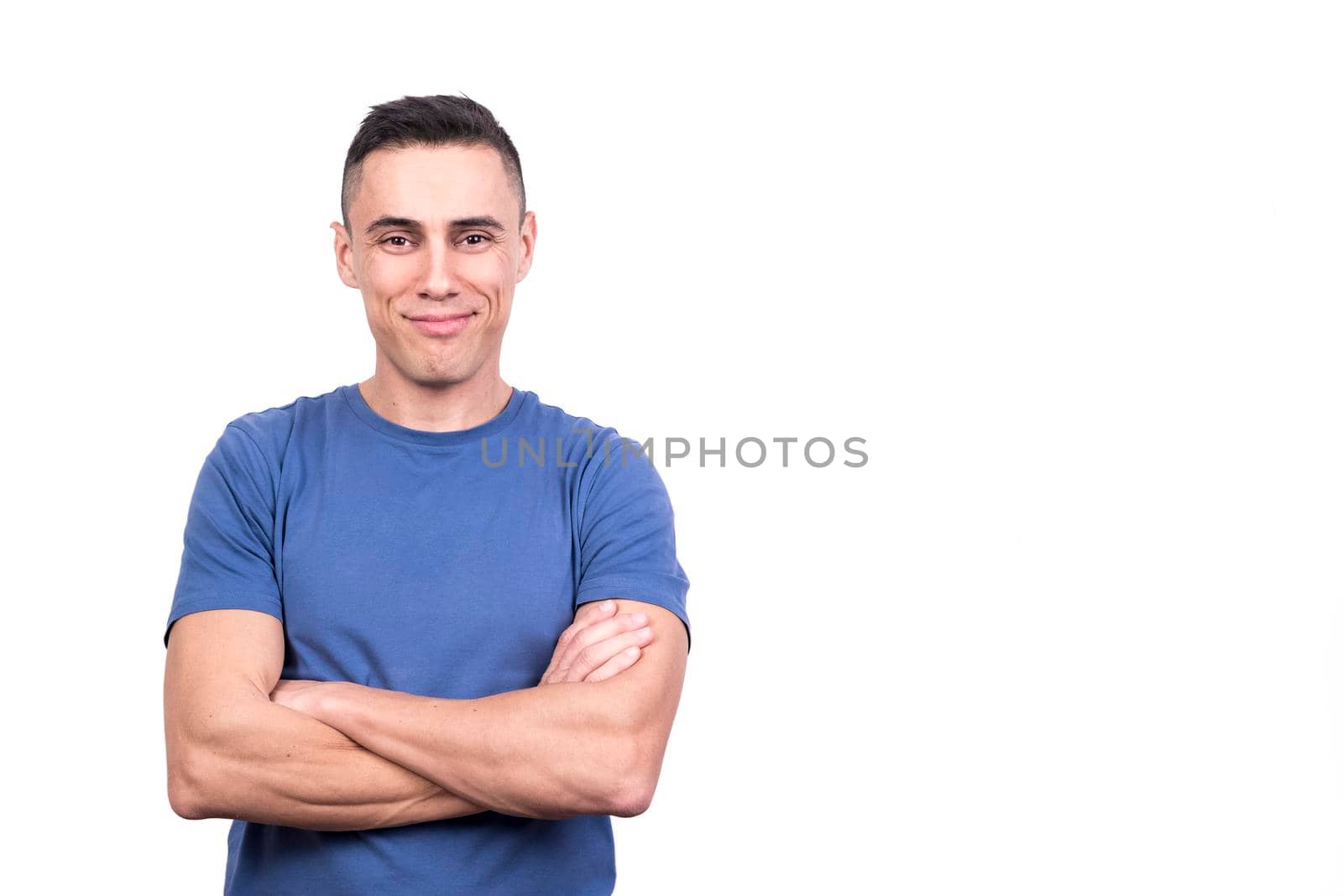 Studio portrait with white background of a man with arms crossed with proud expression