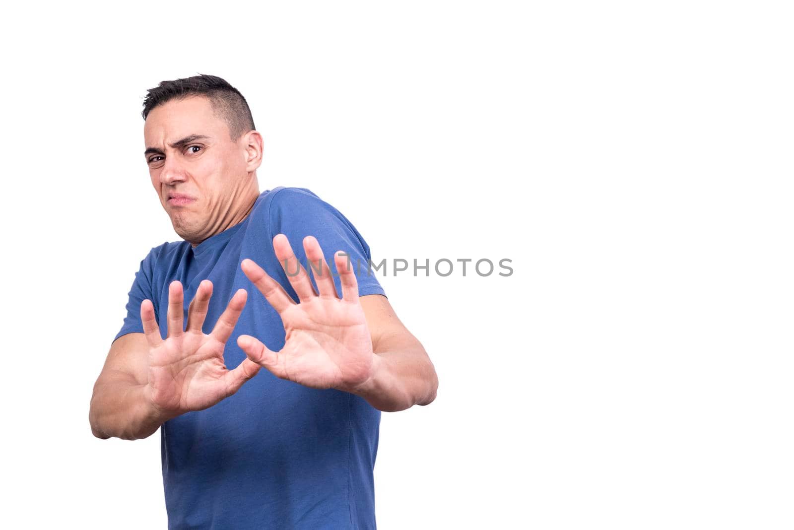 Studio portrait with copy space of a man rejecting something with white background