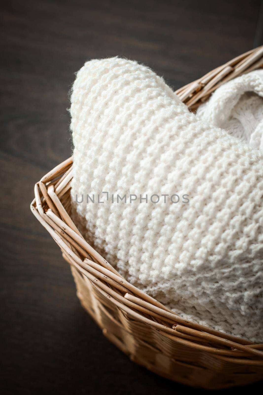 Knitwear, fabric textures and rustic lifestyle concept - Knitted winter clothes in a basket