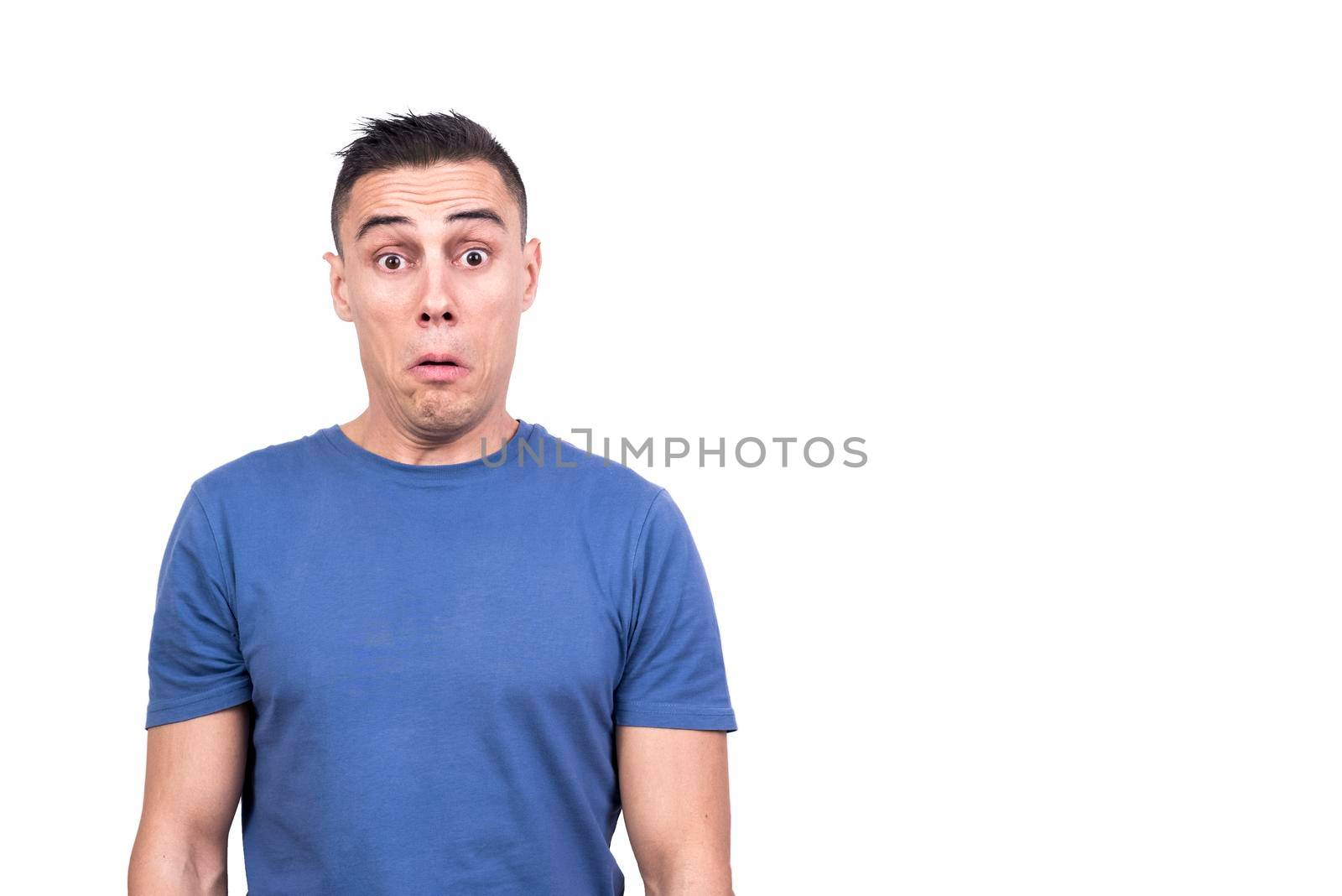 Studio portrait with white background of a man standing with open eyes and unbelieving face