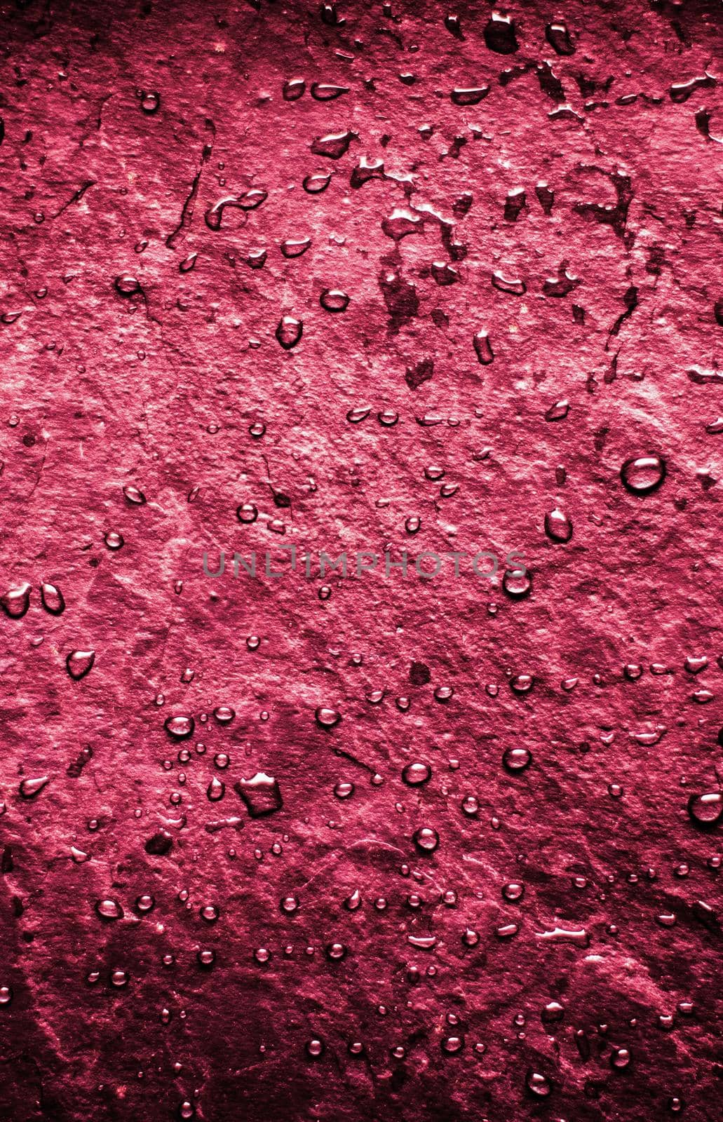 Liquid drops on old stone wall as an abstract background - environmental and vintage concept. Water is the source of life
