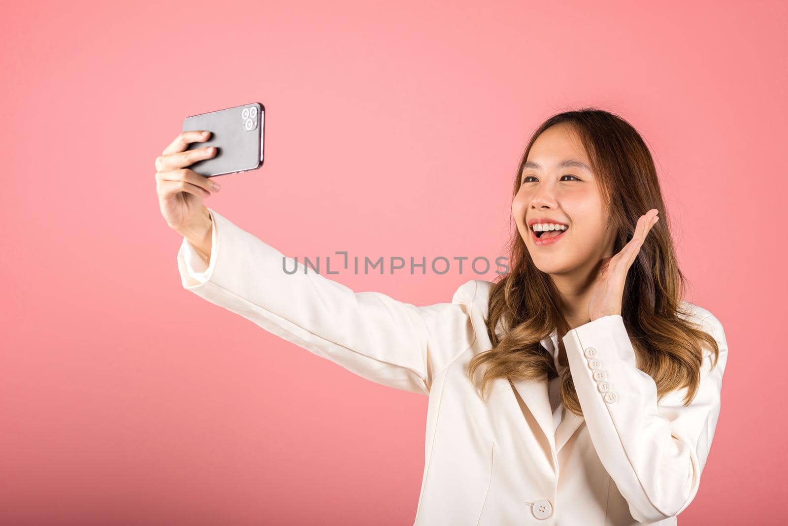 young woman smiling excited  making selfie photo by Sorapop