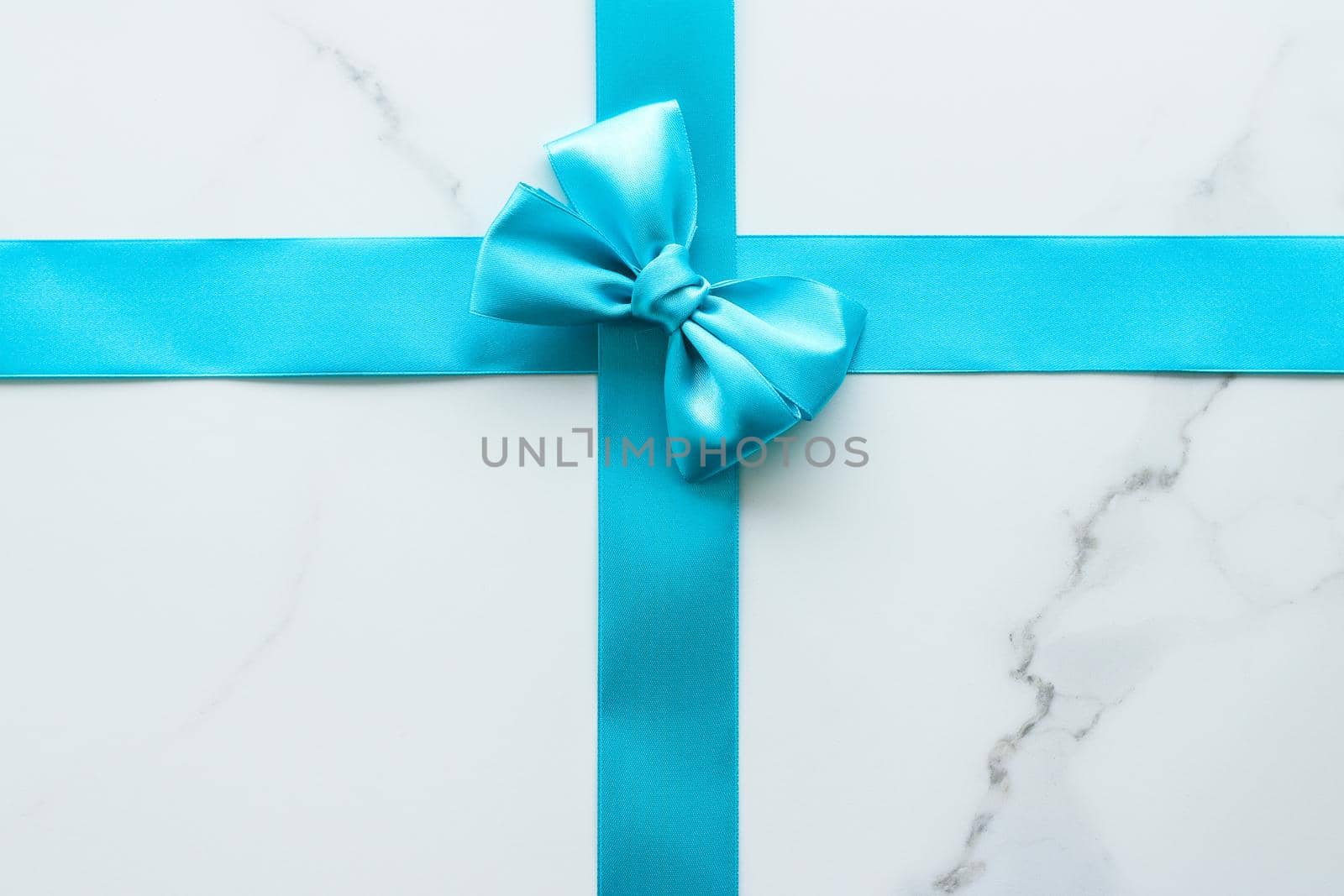 Holiday decor, feminine design and flatlay concept - Blue silk ribbon on marble, top view